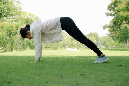 Young asian woman working out at public park.