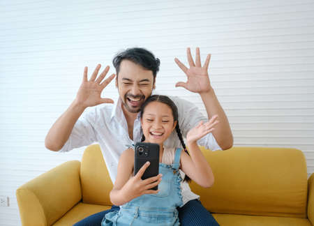 Asian father enjoy to selfie with his daughter.の写真素材