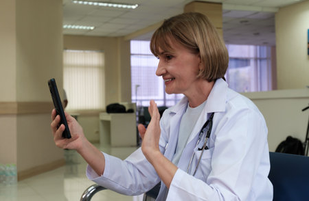 Doctor use mobile to talk consult with patient at home.