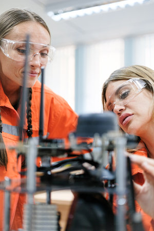 Multiracial tachnicial engineer training with robot arm machine in Robot machine factory workshop.の写真素材