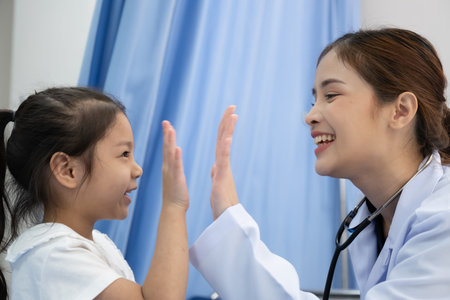 Young female doctor health examination to kid patient in the hospitalの写真素材