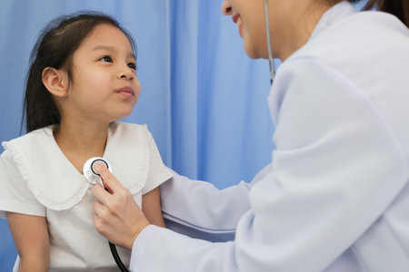 Young female doctor health examination to kid patient in the hospitalの写真素材