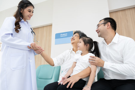 Young female doctor health examination to old female patient and her family sitting on wheelchair.の写真素材