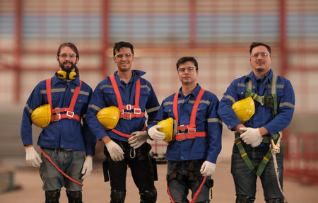 Team of engineers or workers getting safety suits and helmet before working at the factory.