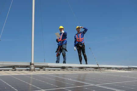 Engineers or workers install and inspect solar cell on the roof of the factory.の写真素材