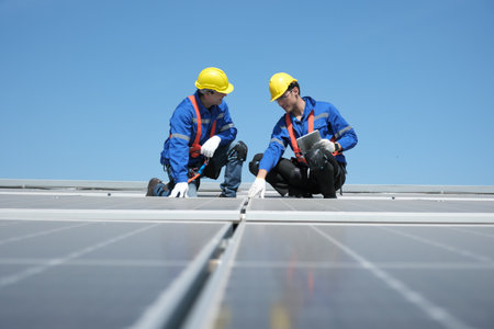 Engineers or workers install and inspect solar cell on the roof of the factory.の写真素材