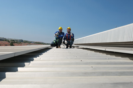 Engineers or workers install and inspect solar cell on the roof of the factory.の写真素材