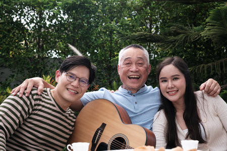 Happy Asian Family enjoy spending time to relaxing with Grand parent in the garden