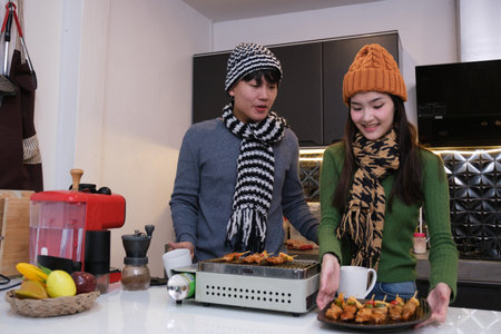 Young Asian couple living at home in winter seasonの写真素材
