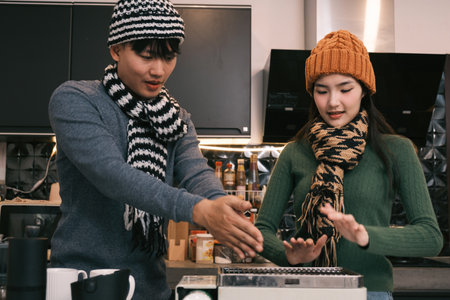 Young Asian couple living at home in winter seasonの写真素材