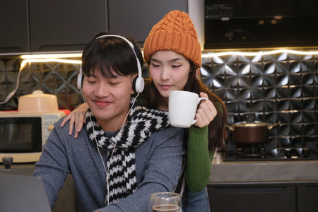 Young Asian couple living at home in winter seasonの写真素材