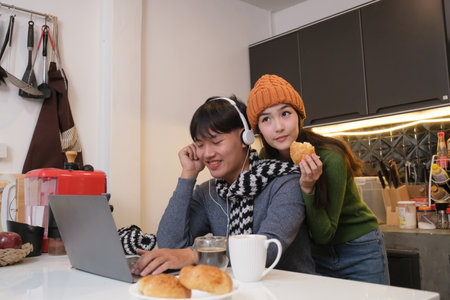 Young Asian couple living at home in winter seasonの写真素材