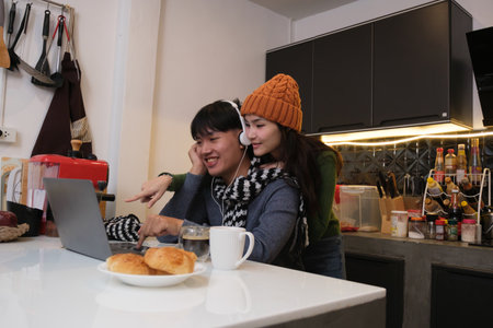 Young Asian couple living at home in winter seasonの写真素材