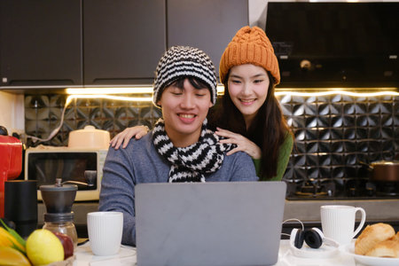 Young Asian couple living at home in winter seasonの写真素材