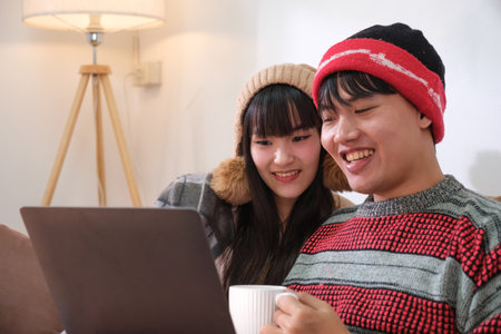 Young Asian couple living at home in winter seasonの写真素材