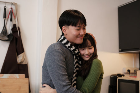 Young Asian couple living at home in winter seasonの写真素材