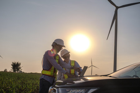 Engineers are inspecting wind turbines to generate electricity.の写真素材