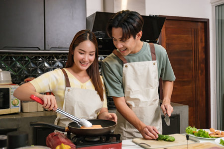 Asian Young couple cooking in the kitchen at home