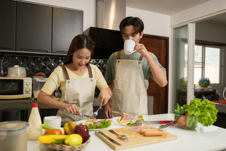 Asian Young couple cooking in the kitchen at home