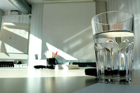 A glass of water on a deskの写真素材