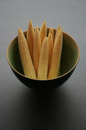 A bowl full of fresh mini cornの写真素材