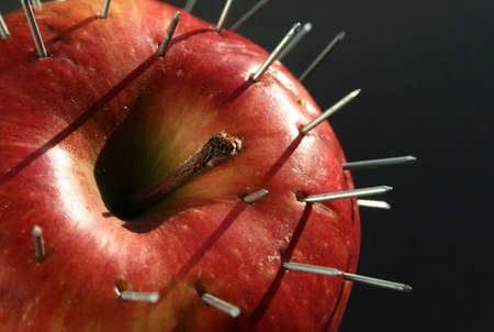 An apple full of nailsの写真素材