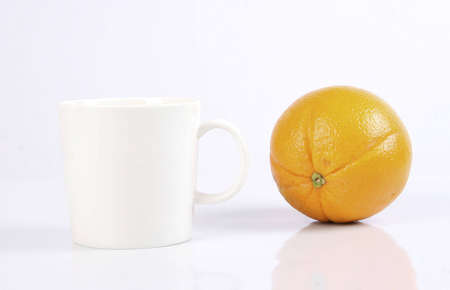 White cup and orangeの写真素材