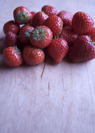  A fresh and juicy strawberry on a wooden table