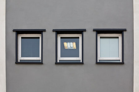 3 windows in gray wallの写真素材