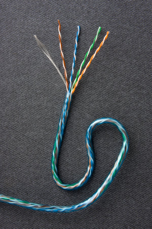 Fiber optic cable , Bare cable string on gray texture  background .