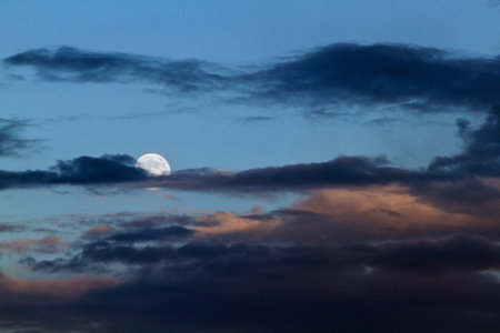 Full moon in dark blue sky with clouds .の写真素材