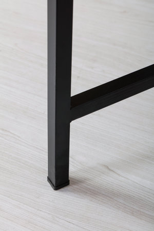 Black metal table stand . Close-up.