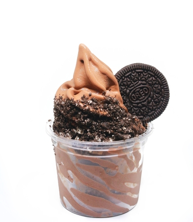 soft serve ice cream in a cup with toppingの写真素材