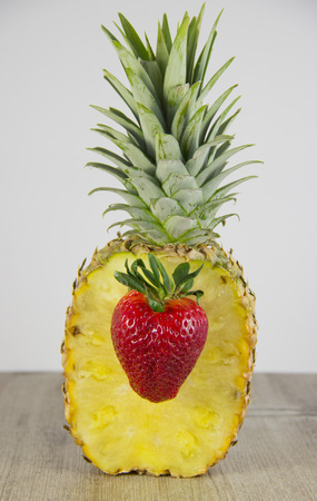 Strawberry as heart for pineappleの写真素材