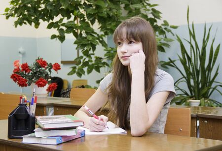 Russia, Krasnoyarsk region, Igarka, December 2015: back to school. the girl sits at her Desk and attentively listens to the teacherのeditorial素材