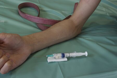 a medical syringe with a flu injection. Human hand ready for vaccinationの写真素材