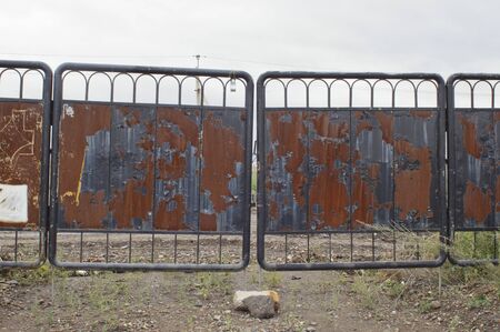 old rusty iron gate on a natural background.