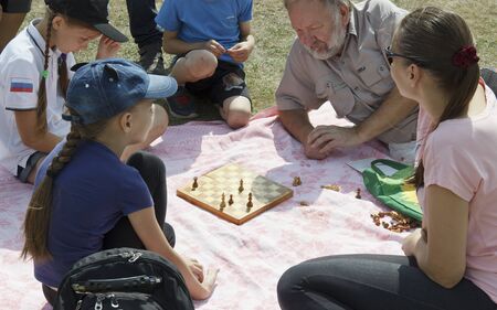 Russia, Krasnoyarsk, July 2019: people play chess in the streetのeditorial素材