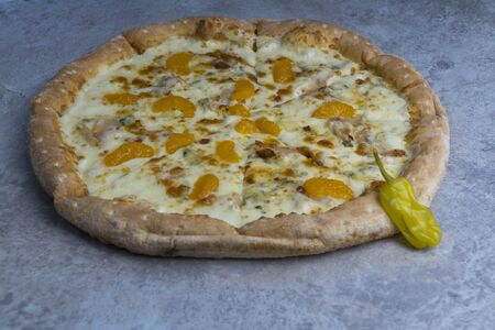 Delicious fruit pizza. Pizza with tangerines on the tableの写真素材