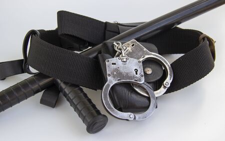 real police handcuffs with case and belt isolated on white background.の写真素材