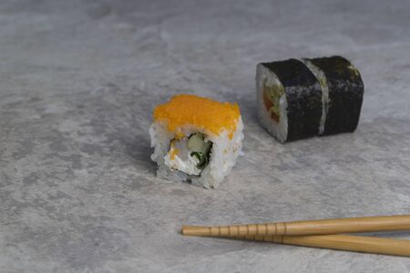 closeup sushi rolls with chopsticks on the table. Japanese food.の写真素材