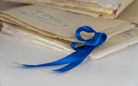 dark blue awareness ribbon on white background. symbolizes the problems of human trafficking and sexual slavery and the problems of malignant neoplasms of the colon and chronic fatigue syndrome.の写真素材