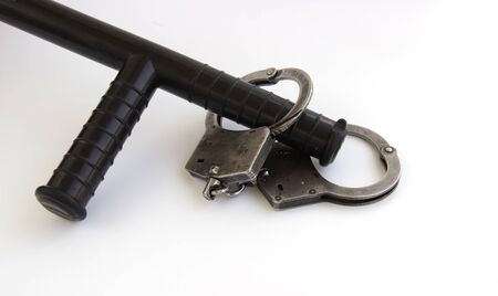 real police handcuffs and baton isolated on white background.