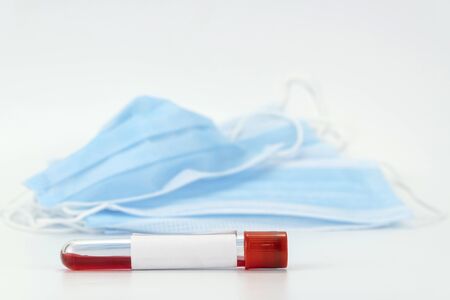 medical protective mask and blood test tube. The concept of preventing the spread of the epidemic...