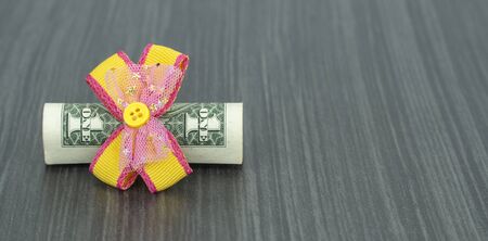 dollar tied with a festive bow. American currency, paper currency notes. perpetual calendar with...