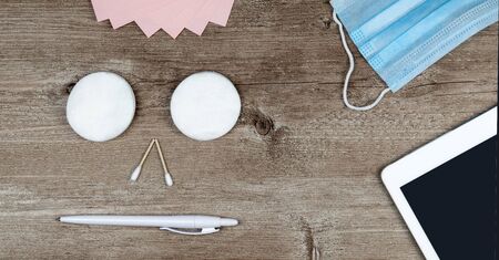 hygiene in the office. Top view close up of office desk, desktop with laptop and medical face mask. global pandemic Coronavirus . remote work or distance learning. home office.の写真素材
