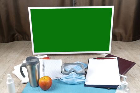 workplace for remote work in quarantine coronavirus pandemic. working from home, wear a protective mask. remote distance work due to the epidemic COVID-19. home officeの写真素材