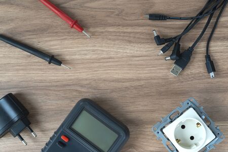 Multimeter and power supply cables. conducting tests and electrical measurements. flat layout, copy...