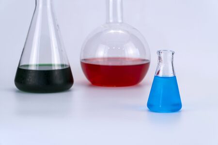 Laboratory glassware with liquid on white background. glass chemical flask with reagent. glass...