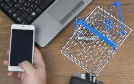 man orders a product on a cell phone. shopping cart. selective focus. online shopping.の写真素材